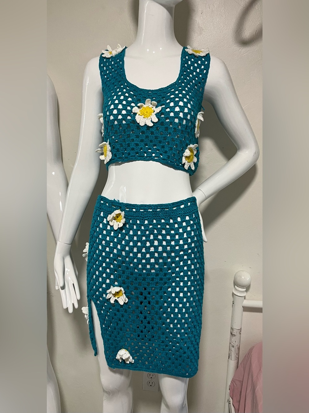 teal crochet two-piece set with daisy patterns.